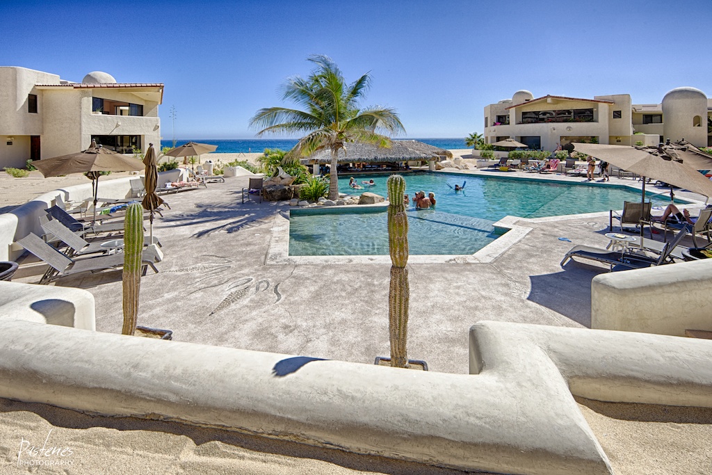 The main pool and palapa swim-up bar at Terrasol Beach Resort, a beachfront condo in Cabo San Lucas, steps from the ocean beach.